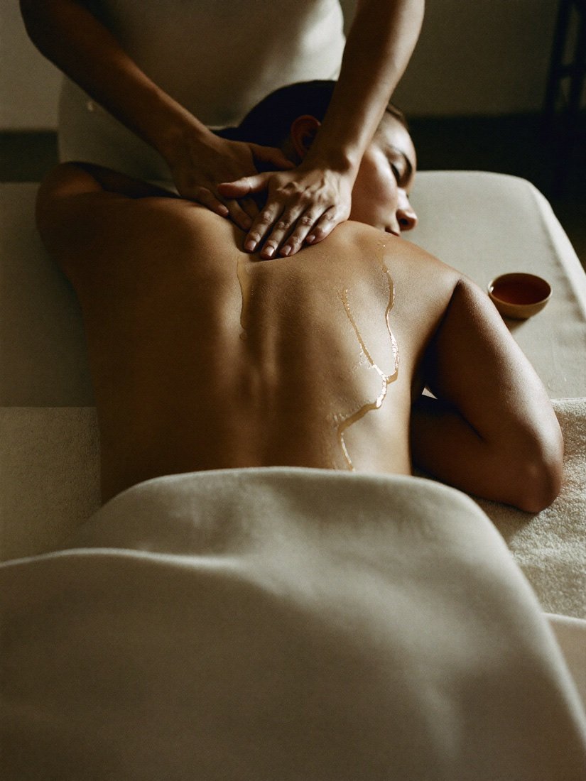 A bare shoulder and neck at rest, intimate and warm